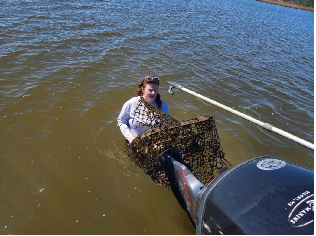 staff in water with derelict crab trap