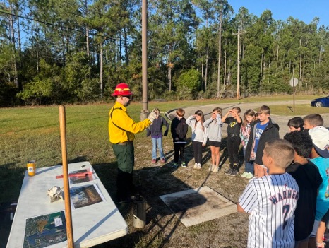 a person outside teaching a group of kids